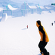 snowboarders approaching a five booter on a bluebird day in shredders